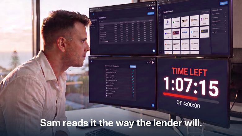 Sam Gardiner reading a development deal at his desk, the four hour clock on the screen behind him